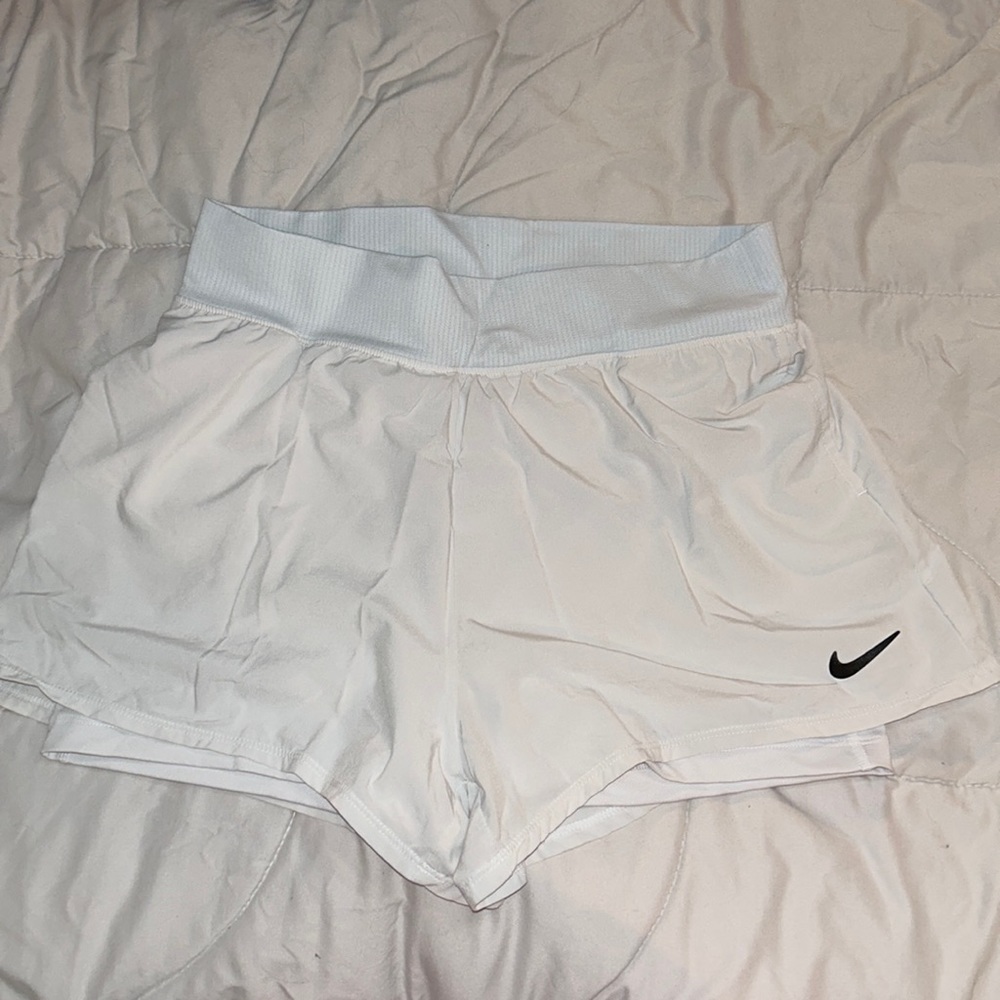 White pockets Nike running shorts